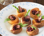 Kleine Yorkshire-Puddings mit Steak und Zwiebelsauce