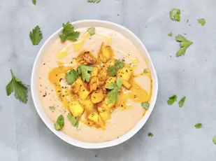 Schale mit Maronensuppe, Birnenwürfel und Nüssen als Topping und gehackter Petersilie