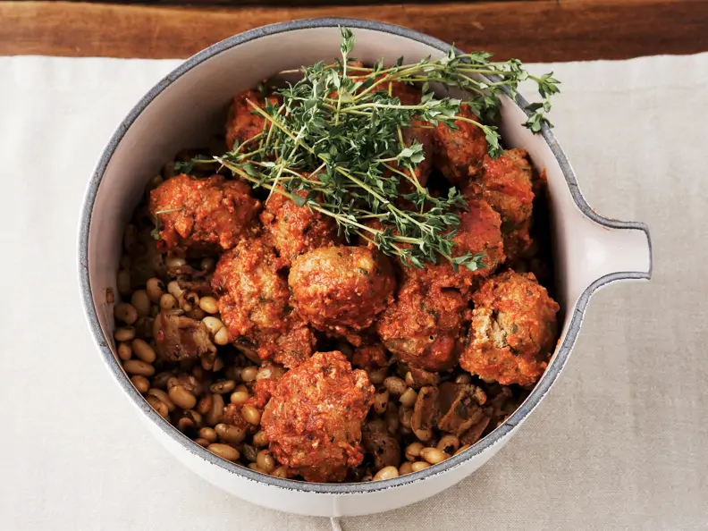 Hackbällchen in Tomaten-Knoblauch-Sauce auf Bohnen