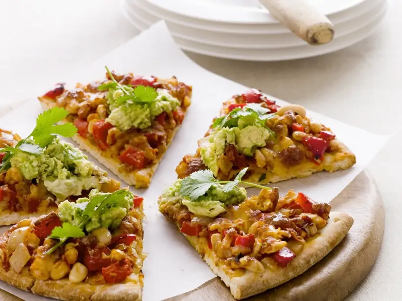 Pizza mit Mais, Paprika und Avocadocreme
