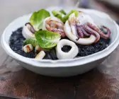Calamari mit schwarzem Reis und Rosenkohlblättern