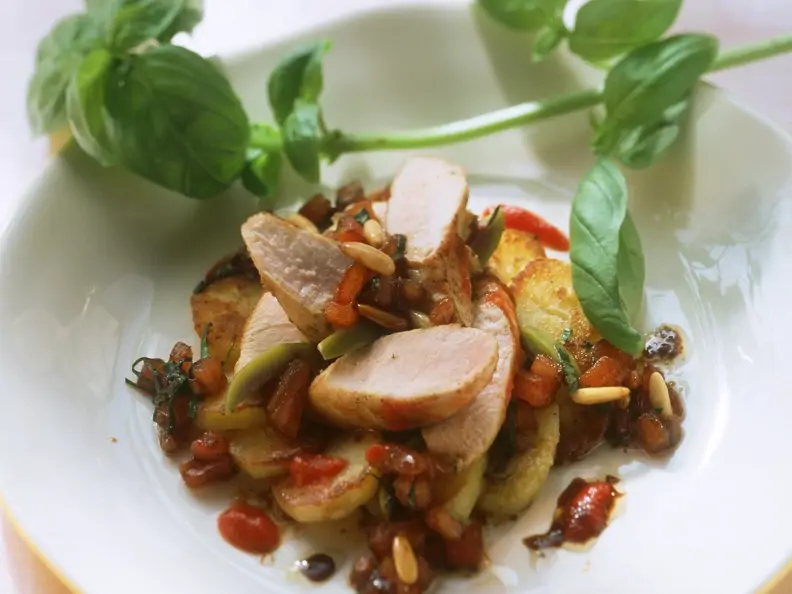 Salat von Bratkartoffeln, Kaninchen und Pinienkernen, dazu Basilikum