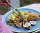 Gegrillte Hähnchenroulade mit gemischtem Salat und Maiskolben