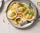 Kürbis-Ravioli mit Pinienkernen und Rucola